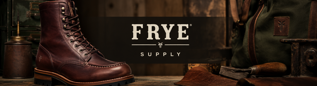 A brown leather lace-up work boot displayed on a rustic wooden surface with a dark central banner reading 'FRYE SUPPLY.