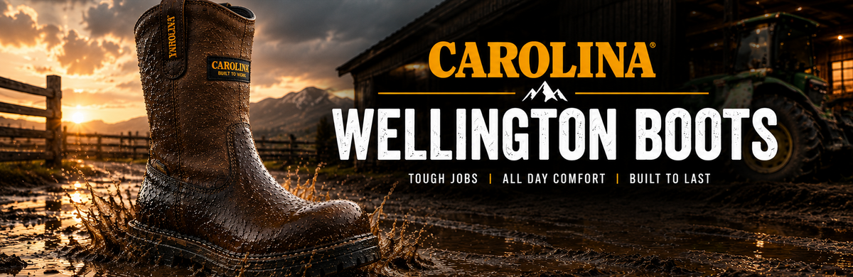 A single Carolina Wellington boot stands in muddy water outdoors at sunset, with a barn and tractor in the background and large text reading 'CAROLINA WELLINGTON BOOTS' across the right side.