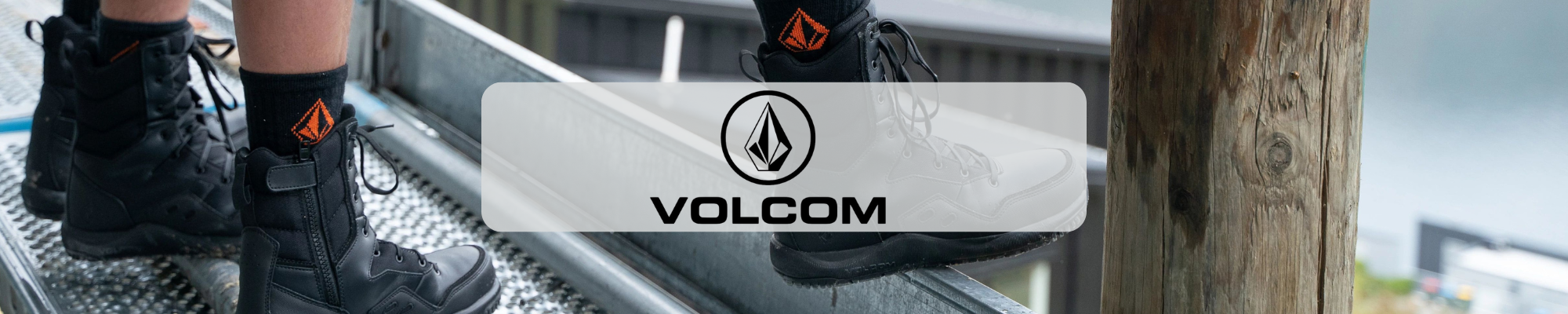 Volcom logo over black work boots on a metal work platform