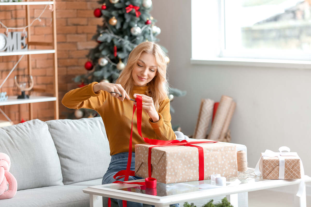 woman wrapping shoes in a gift box
