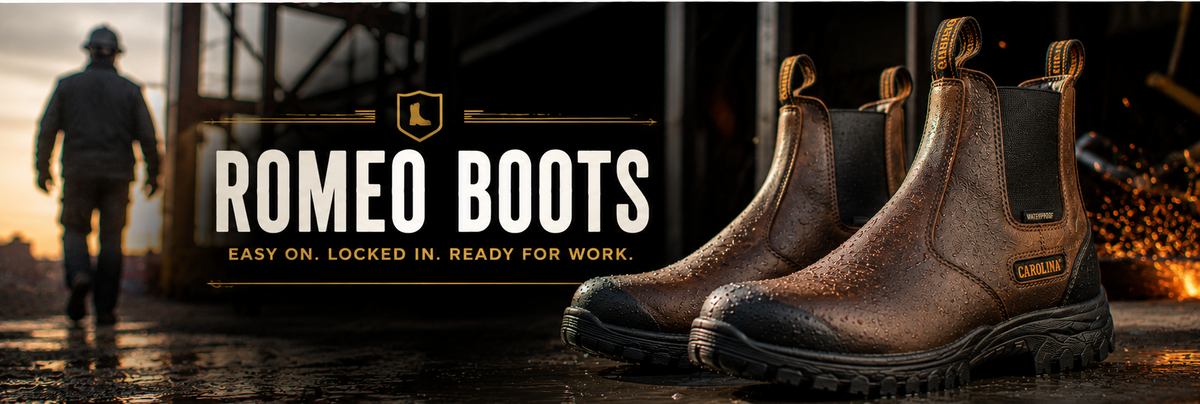 Pair of brown leather Romeo Boots with black elastic side panels, shown in the foreground against a dark industrial background with a worker silhouette and sparks.