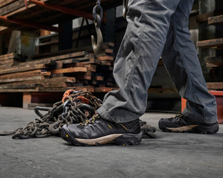 legs in boots standing in warehouse